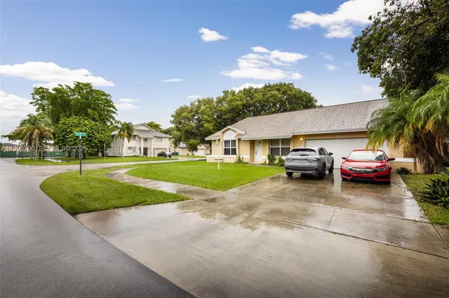 a view of a house with swimming pool and deck