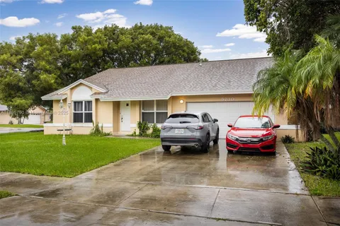 a car parked in front of a house with a garden