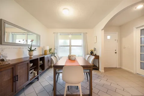 a view of a dining room with furniture and window