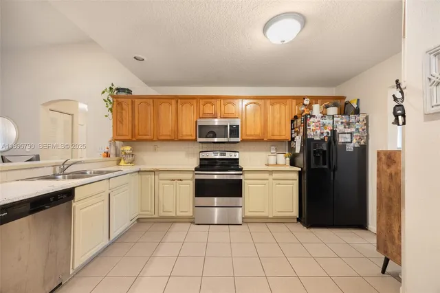 a kitchen with a stove sink and refrigerator