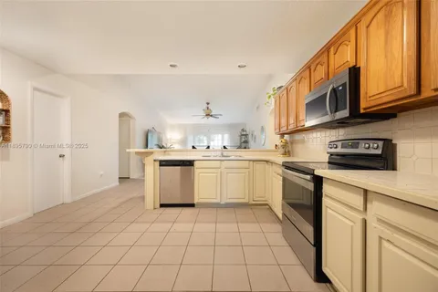 a kitchen with stainless steel appliances granite countertop a sink and cabinets