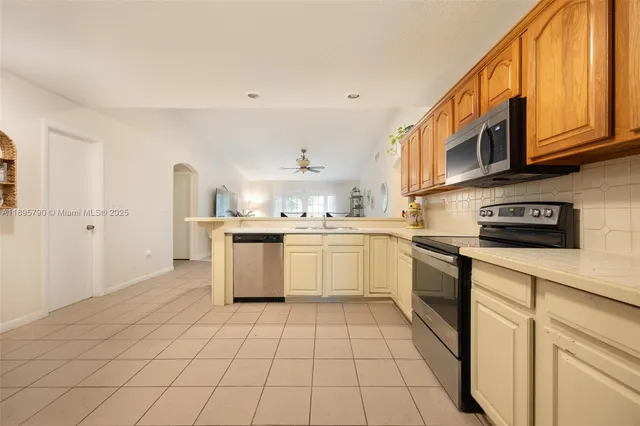 a kitchen with stainless steel appliances granite countertop a sink and cabinets