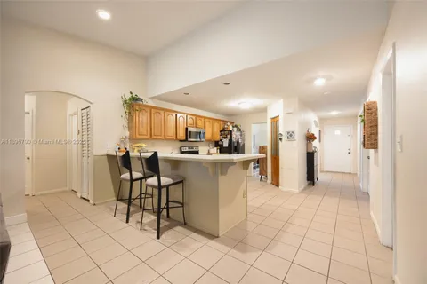 a view of kitchen with furniture and refrigerator