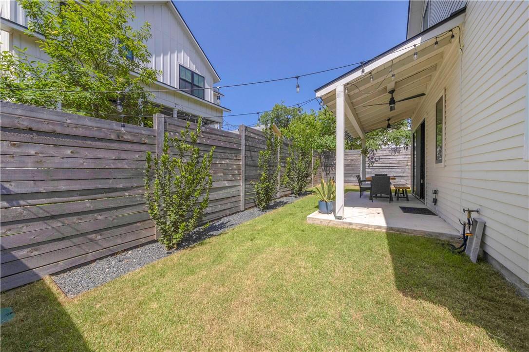 2002 East 9th Street, Unit 2 Austin, TX 78702 - Photo 20 of 32 A private backyard oasis awaits, featuring a covered patio perfect for outdoor entertaining.