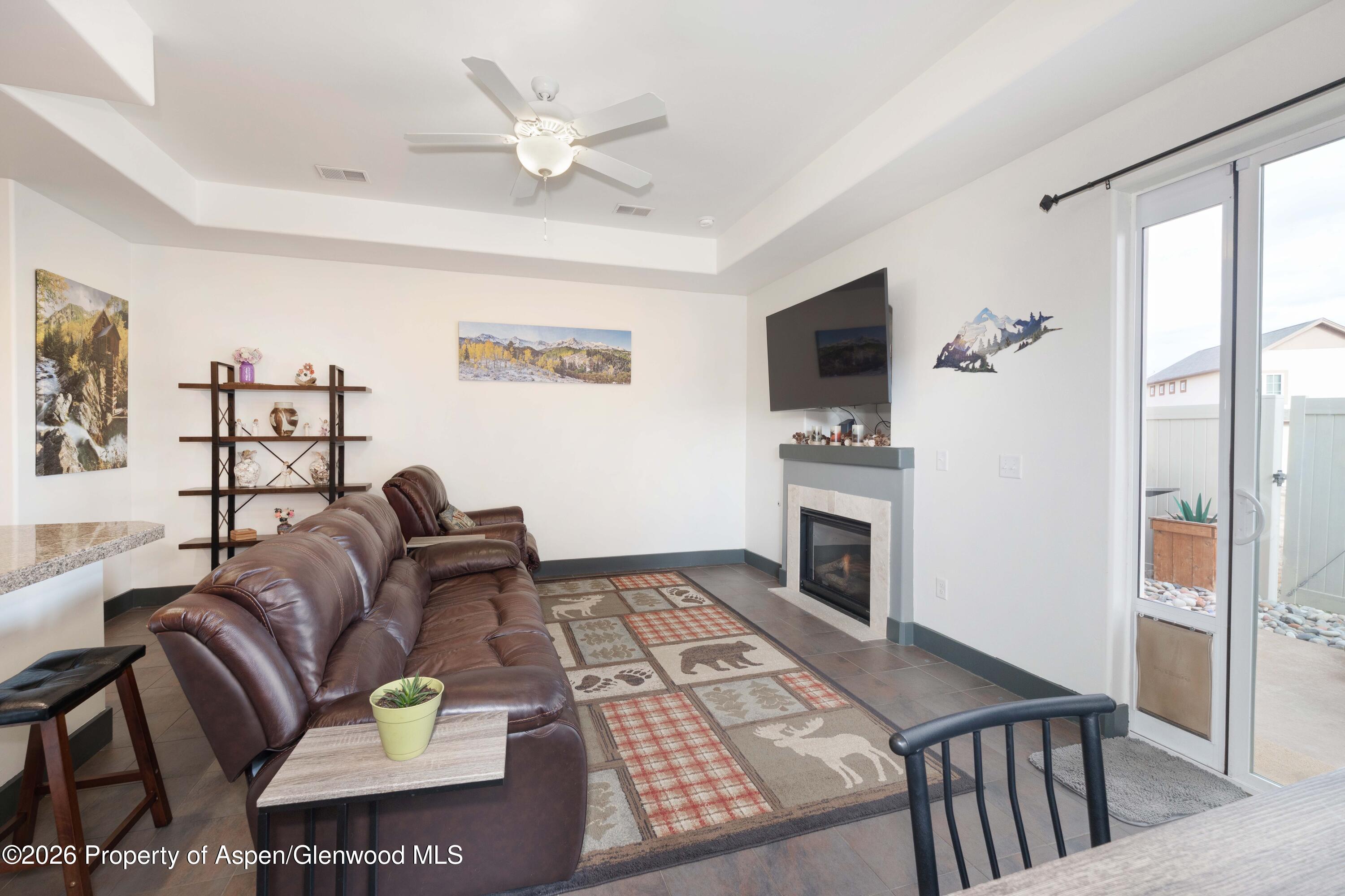 860 West 24th Street Rifle, CO 81650 - Photo 4 of 12 a living room with furniture fireplace and flat screen tv