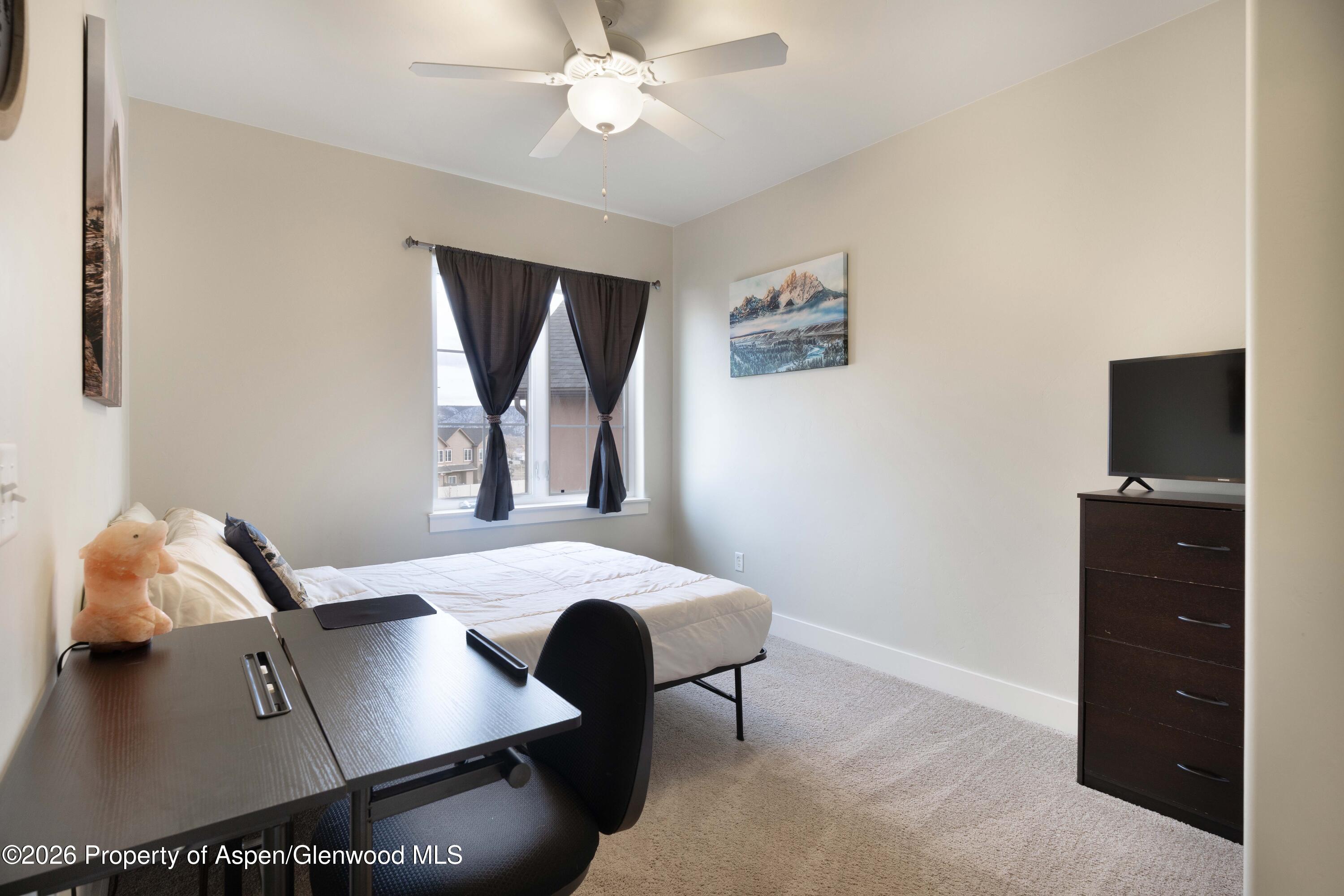 860 West 24th Street Rifle, CO 81650 - Photo 10 of 12 a living room with furniture and a flat screen tv