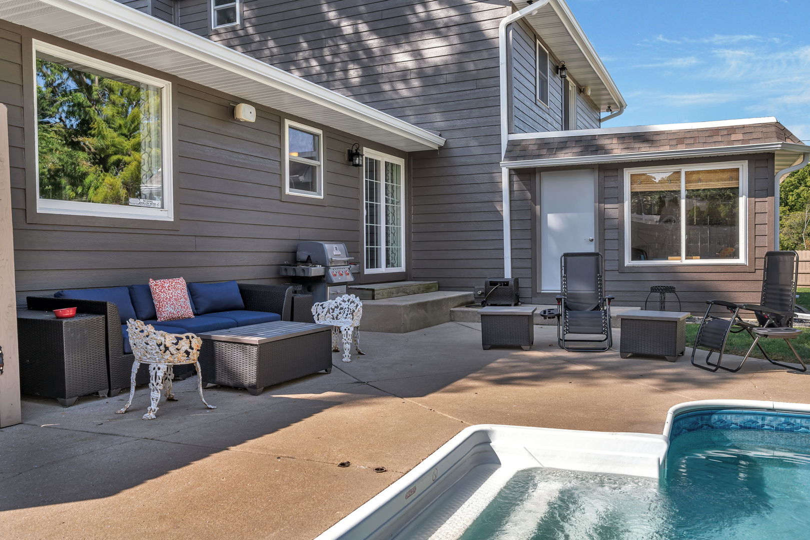 3509 Green Meadow Lane Joliet, IL 60431 - Photo 12 of 44 a view of a house and a swimming pool with a couches and lounge chairs