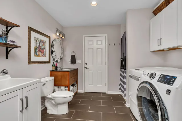 a bathroom with a toilet sink and mirror