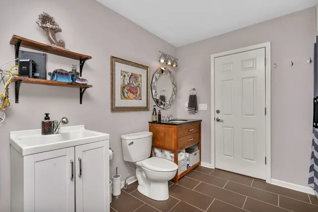 a bathroom with a toilet sink and mirror