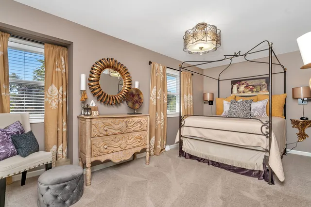 a bedroom with a bed and a chandelier