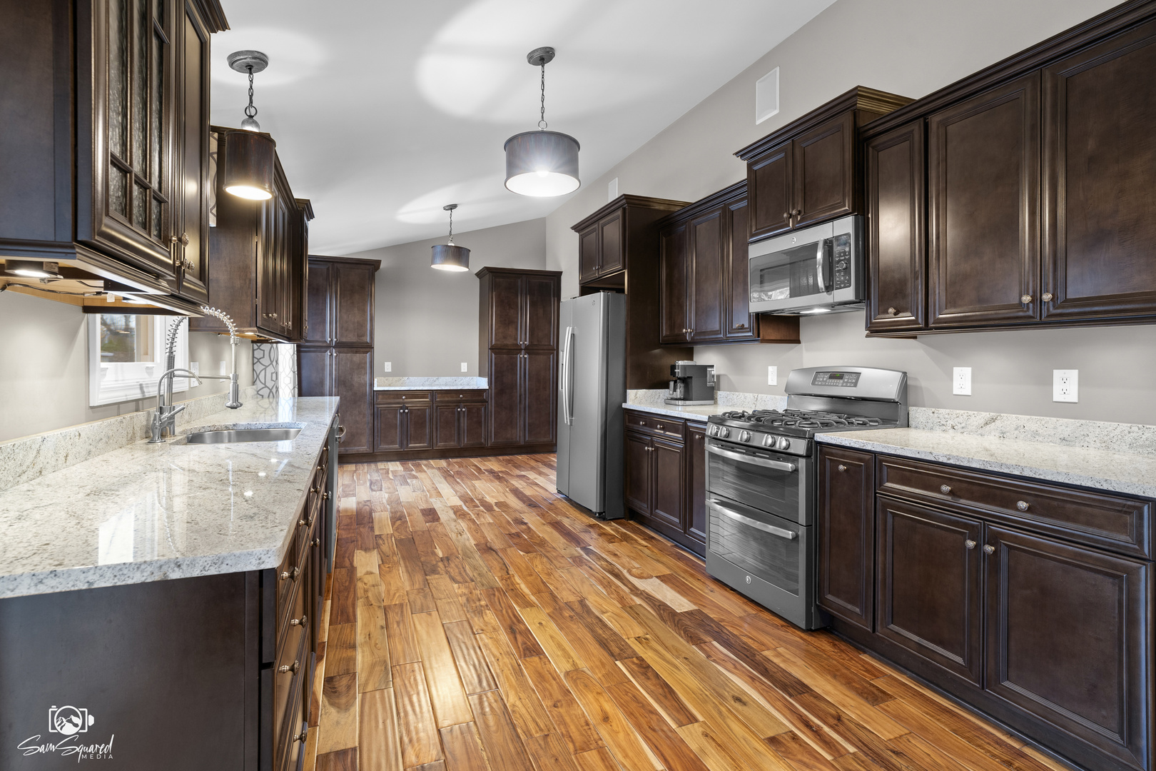 3509 Green Meadow Lane Joliet, IL 60431 - Photo 26 of 44 a large kitchen with stainless steel appliances kitchen island granite countertop a stove a sink dishwasher and a microwave oven with large wooden cabinets