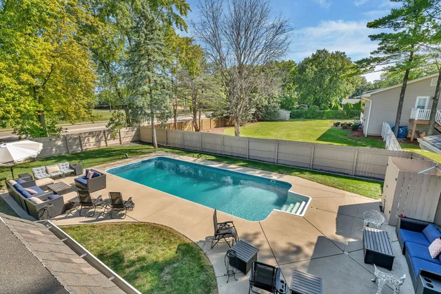 a view of a backyard with swimming pool
