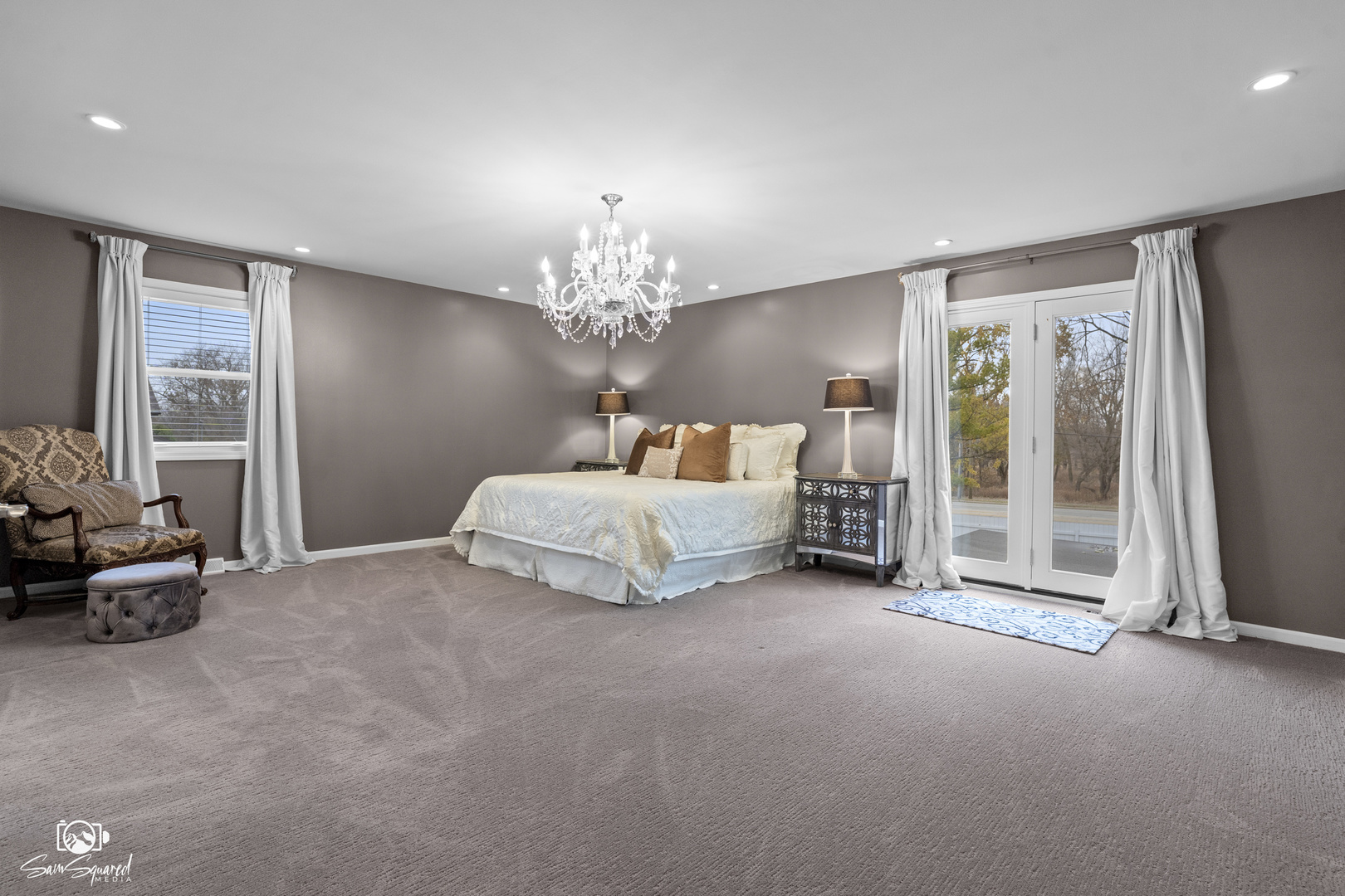 3509 Green Meadow Lane Joliet, IL 60431 - Photo 33 of 44 a spacious bedroom with a bed and a chandelier