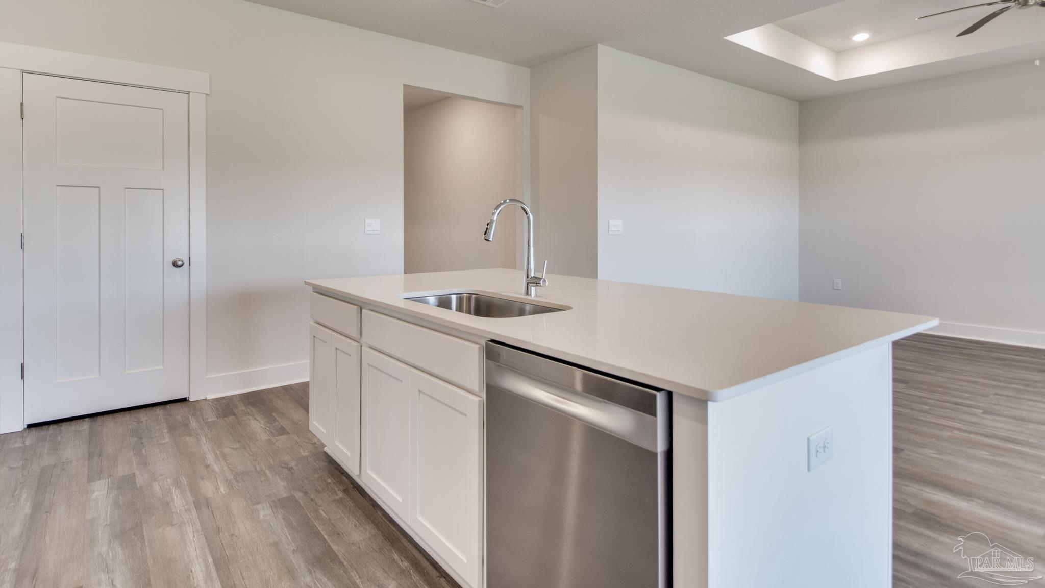 3463 Crossvine Road Cantonment, FL 32533 - Photo 7 of 33 a kitchen with a sink cabinets and wooden floor