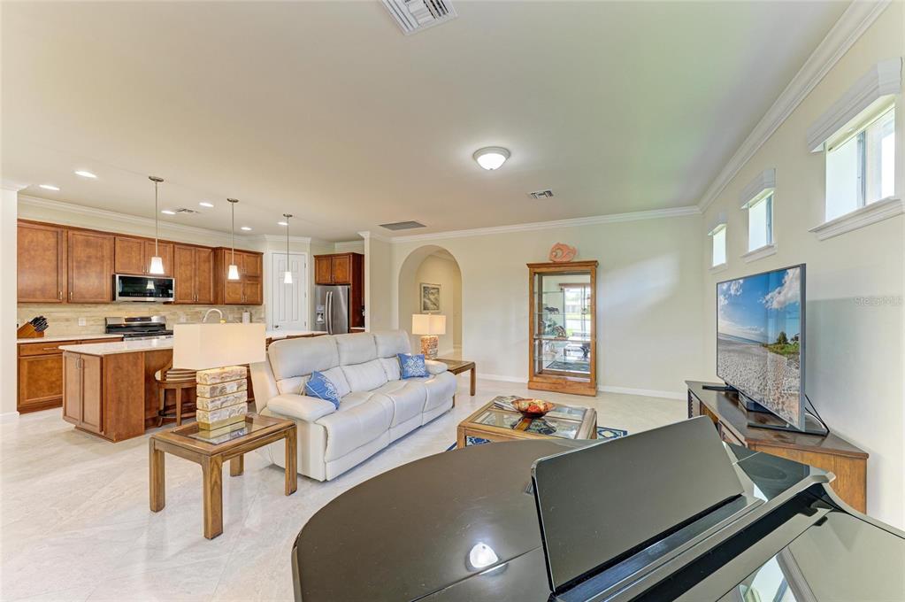 6756 Chester Trail Lakewood Ranch, FL 34202 - Photo 13 of 62 a living room with furniture and a flat screen tv