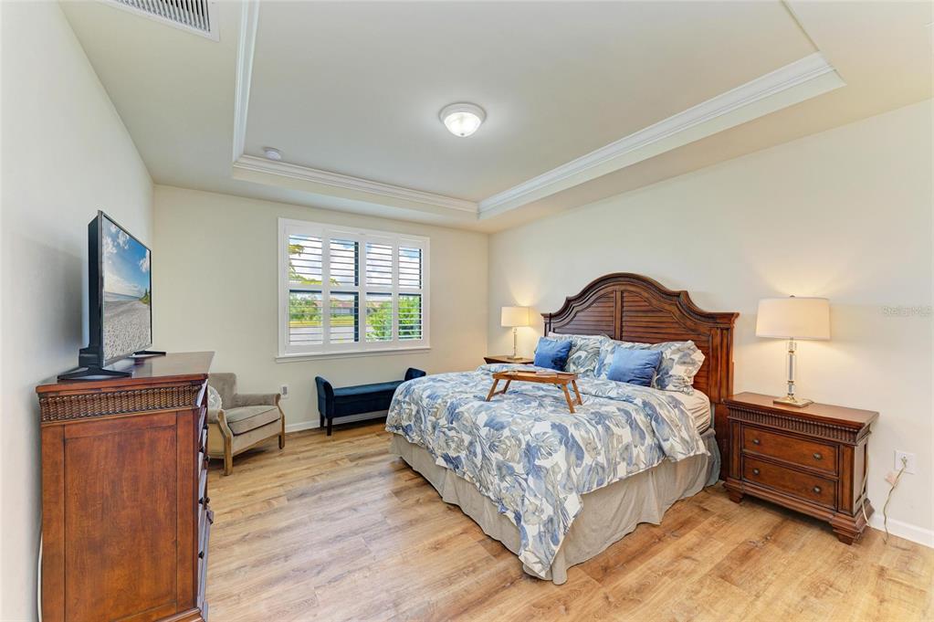 6756 Chester Trail Lakewood Ranch, FL 34202 - Photo 20 of 62 a bedroom with a bed and a flat screen tv