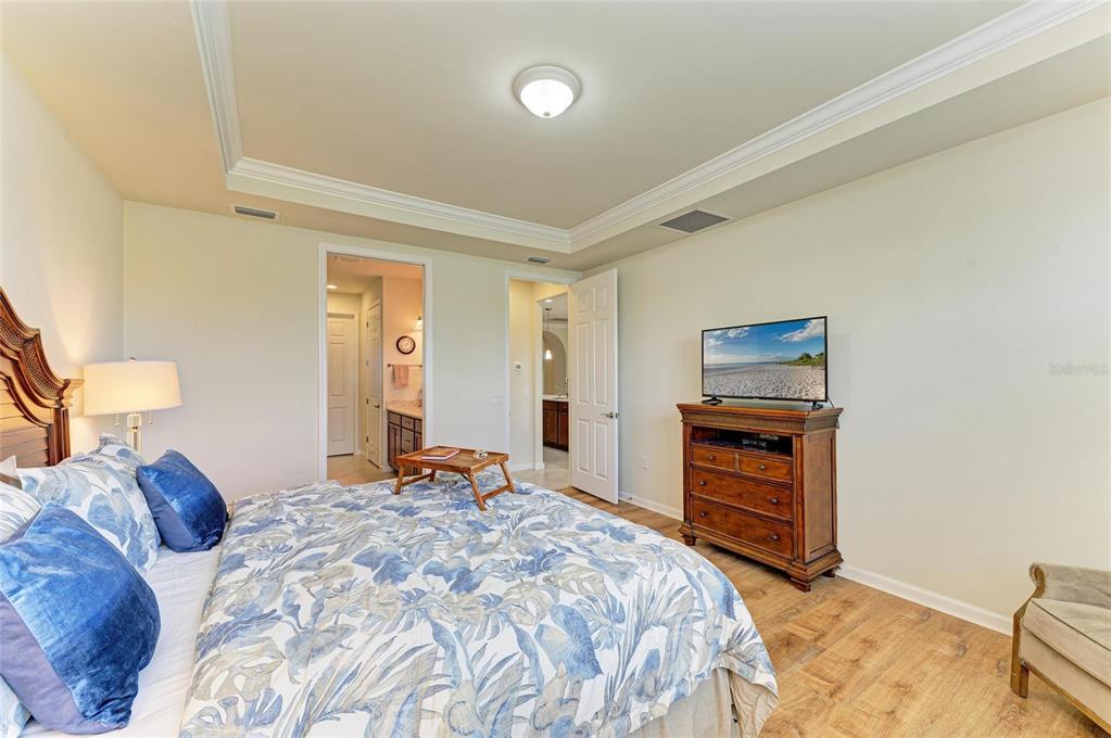 6756 Chester Trail Lakewood Ranch, FL 34202 - Photo 23 of 62 a bedroom with a bed and a television