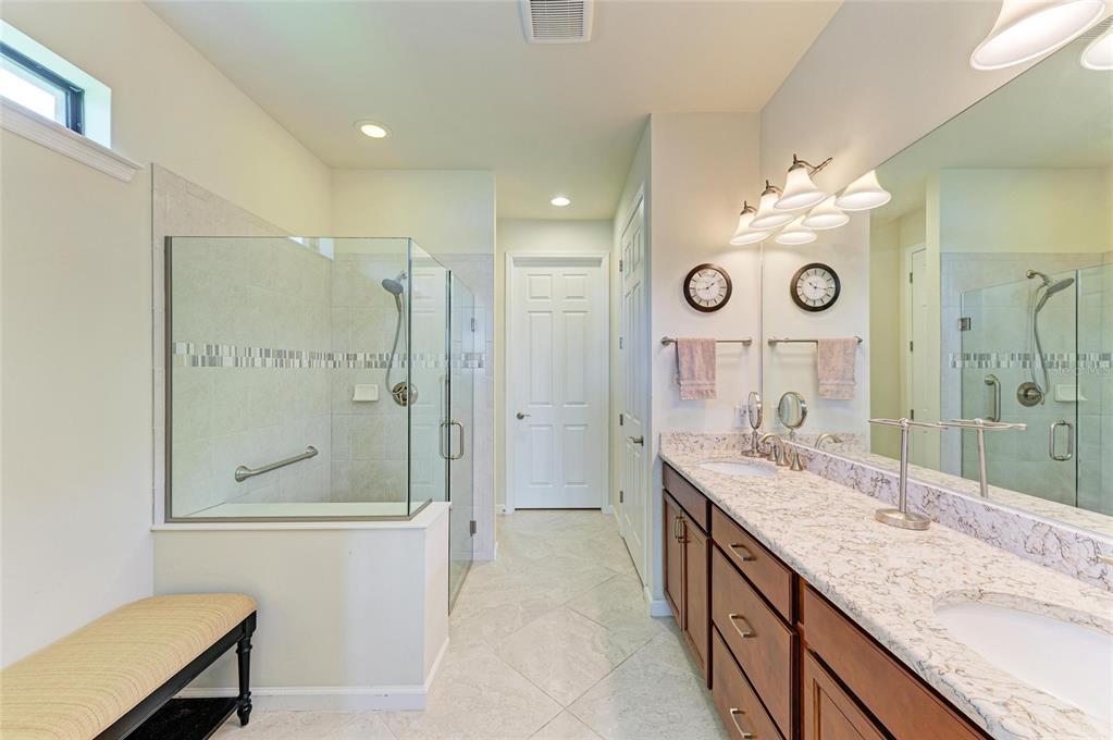 6756 Chester Trail Lakewood Ranch, FL 34202 - Photo 24 of 62 a bathroom with a granite countertop sink mirror and a shower