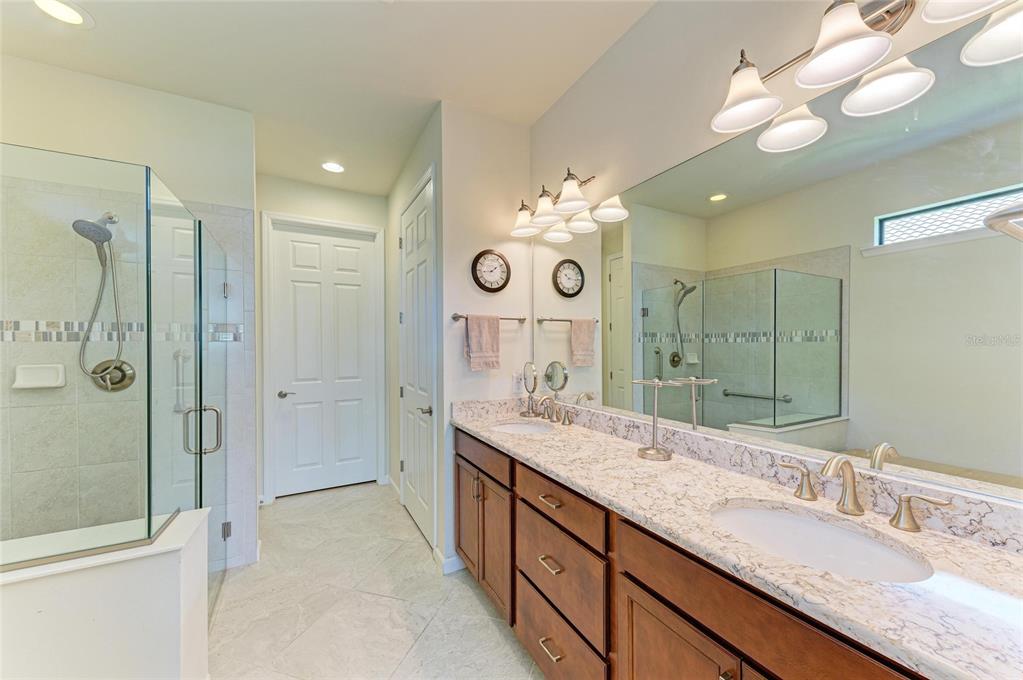 6756 Chester Trail Lakewood Ranch, FL 34202 - Photo 25 of 62 a spacious bathroom with a granite countertop double vanity sink mirror and shower