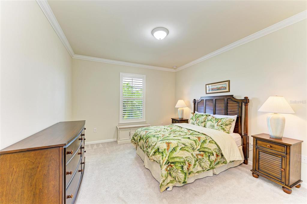 6756 Chester Trail Lakewood Ranch, FL 34202 - Photo 29 of 62 a bedroom with a bed and a night stand