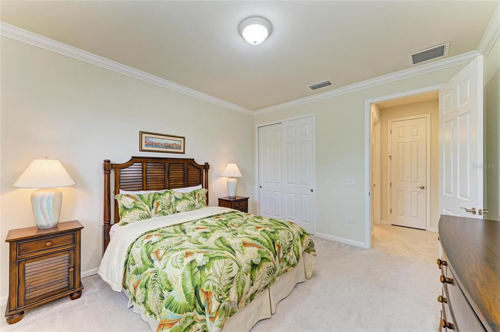 6756 Chester Trail Lakewood Ranch, FL 34202 - Photo 30 of 62 a bedroom with a bed and a lamp
