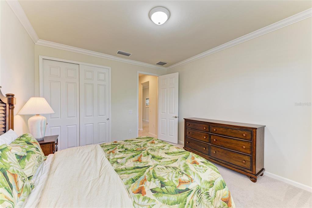 6756 Chester Trail Lakewood Ranch, FL 34202 - Photo 31 of 62 a bedroom with a bed and a lamp on dresser