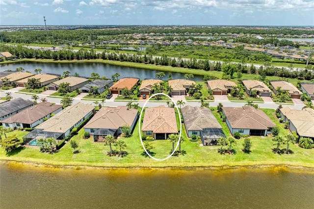 a living room with lots of furniture and a view of kitchen