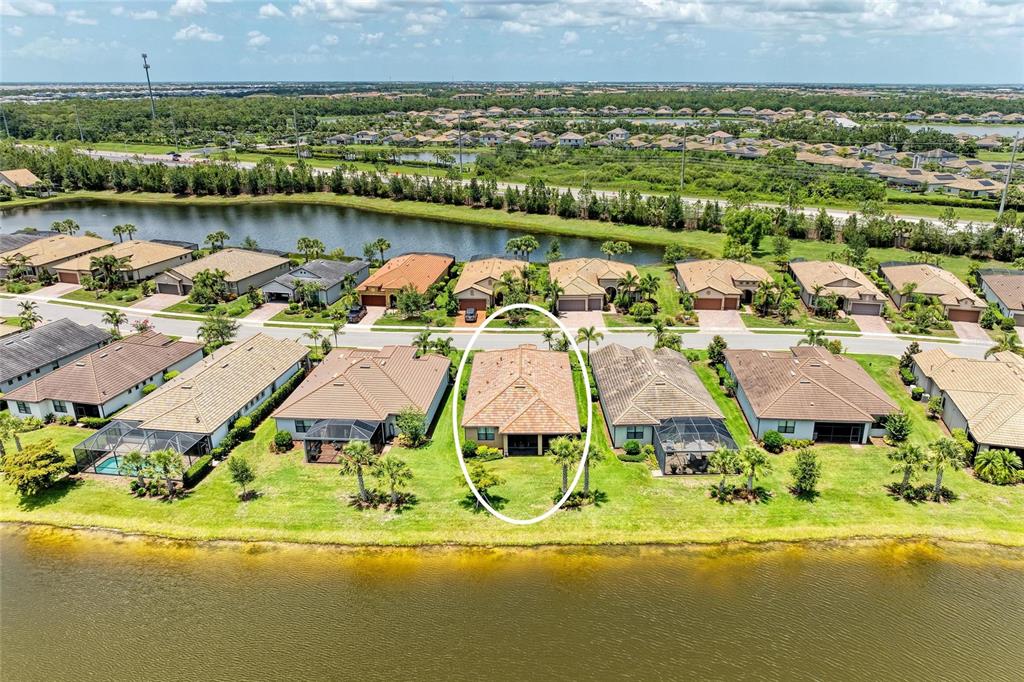 6756 Chester Trail Lakewood Ranch, FL 34202 - Photo 44 of 62 an aerial view of residential house with outdoor space and lake view
