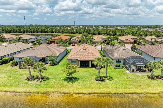 a view of an empty room with wooden floor and a windows