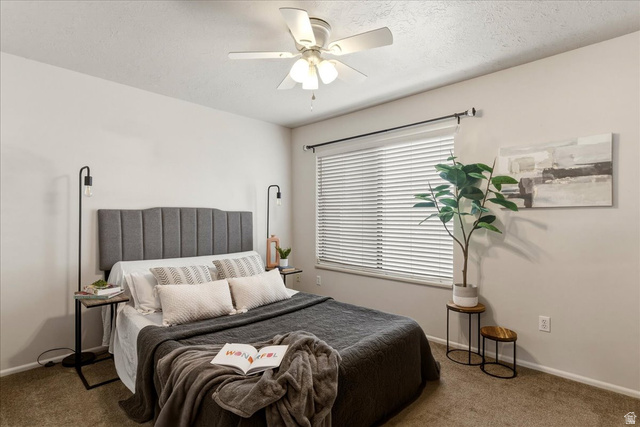 947 Canyon Road, Unit 29 Ogden, UT 84404 - Photo 12 of 19 Carpeted bedroom with a textured ceiling and ceiling fan