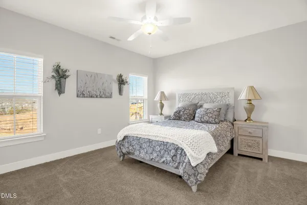 a spacious bedroom with a bed and a window