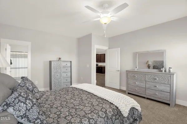 a bedroom with a bed and a dresser