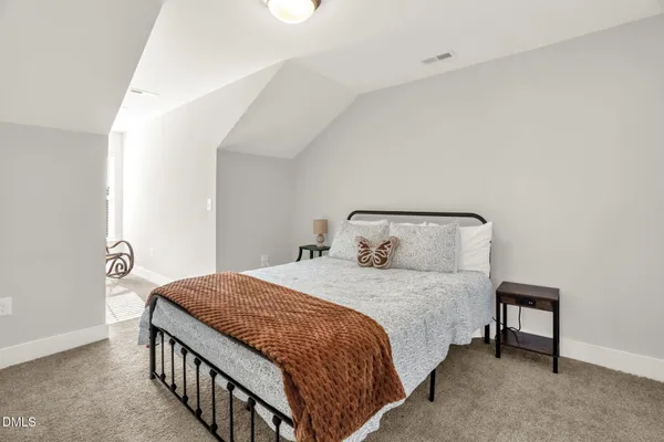a bedroom with a bed and a lamp