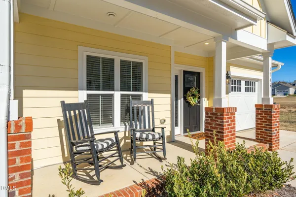 a view of a patio with table and chairs and wooden floor