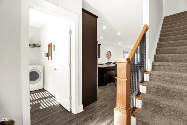 a view of a hallway with wooden floor and staircase