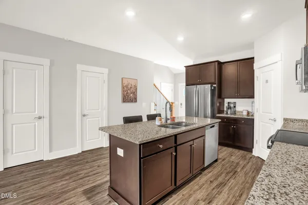 a kitchen with a sink stove and refrigerator