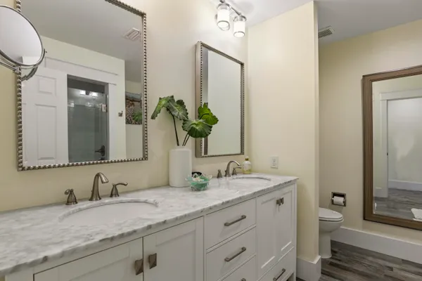a bathroom with a granite countertop sink and a mirror