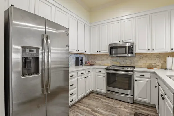 a kitchen with stainless steel appliances cabinets and a counter top space