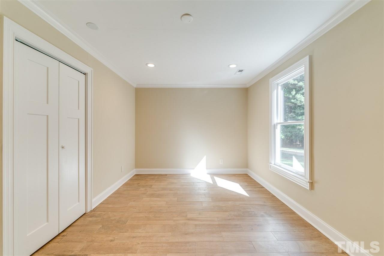 11908 Six Forks Road Raleigh, NC 27614 - Photo 14 of 25 a view of an empty room with wooden floor and a window