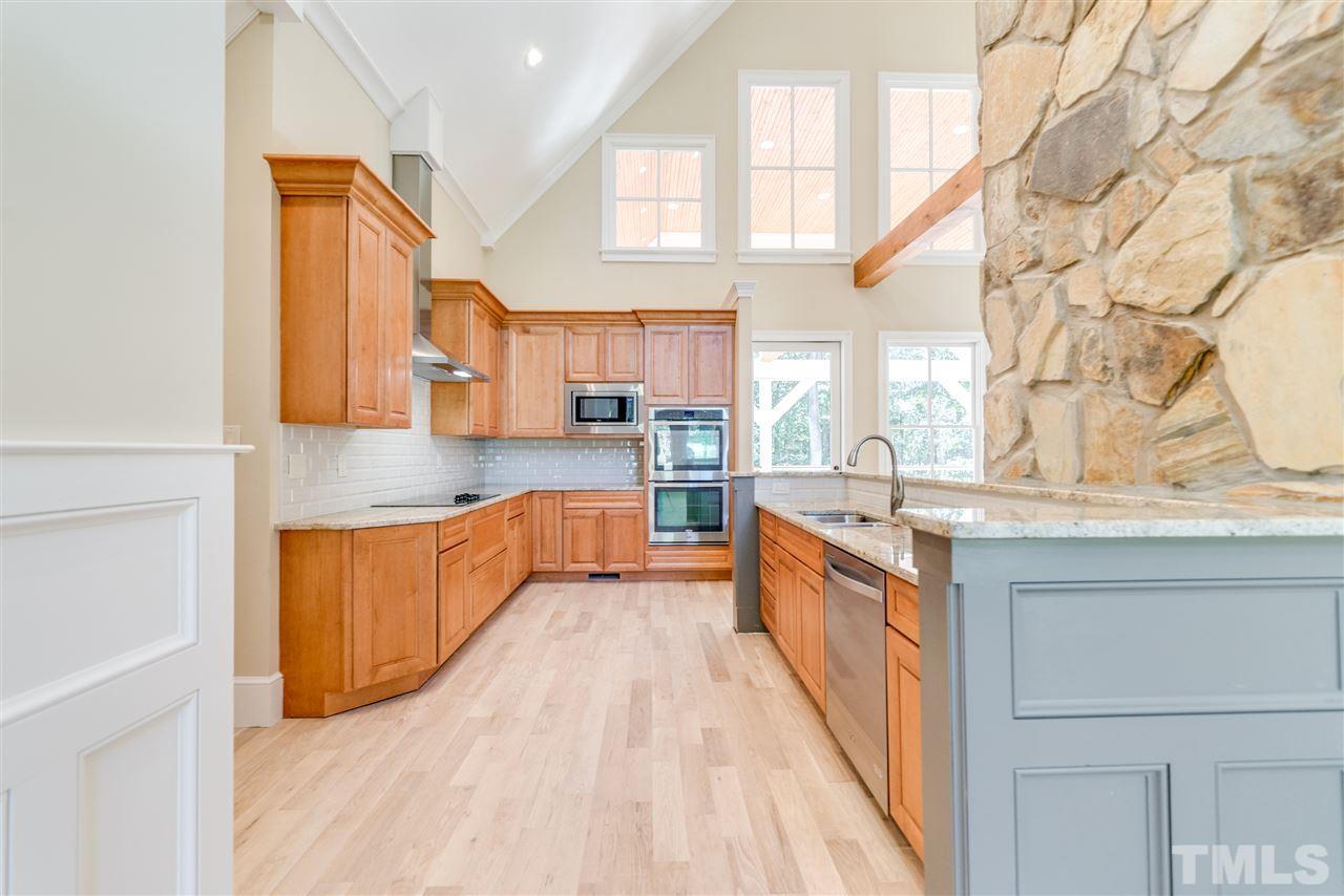 11908 Six Forks Road Raleigh, NC 27614 - Photo 5 of 25 a large kitchen with stainless steel appliances granite countertop a large counter top a stove and a refrigerator