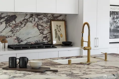 a view of a kitchen with sink and natural light
