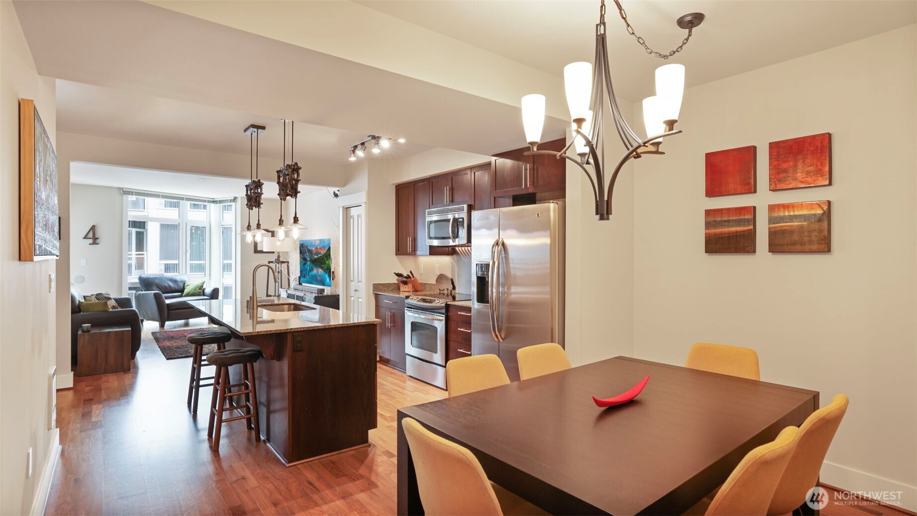 699 John Street, Unit 513 Seattle, WA 98109 - Photo 2 of 33 a view of a dining room and livingroom with furniture wooden floor a chandelier