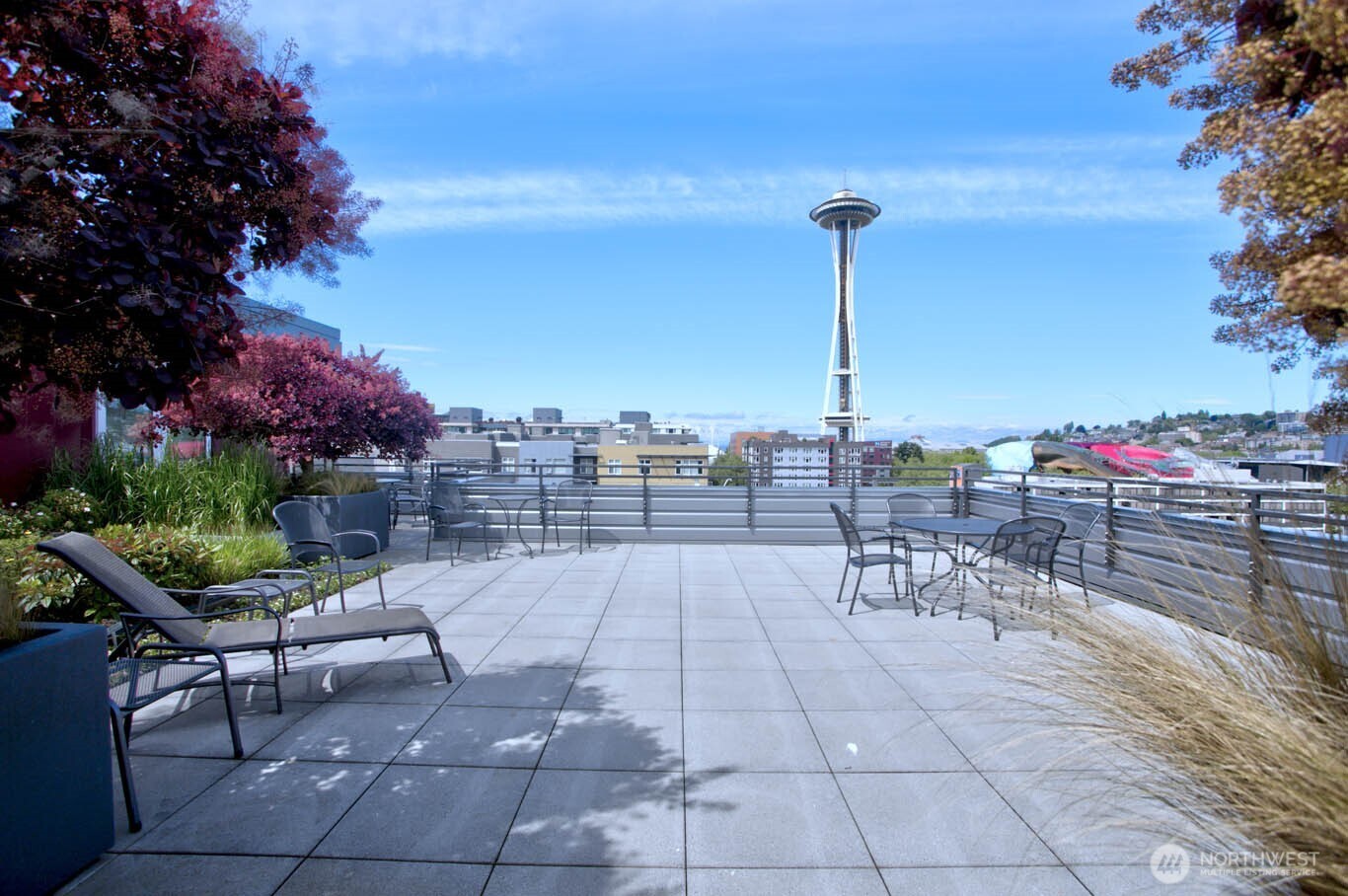 699 John Street, Unit 513 Seattle, WA 98109 - Photo 23 of 33 a view of a patio with a table and chairs and potted plants