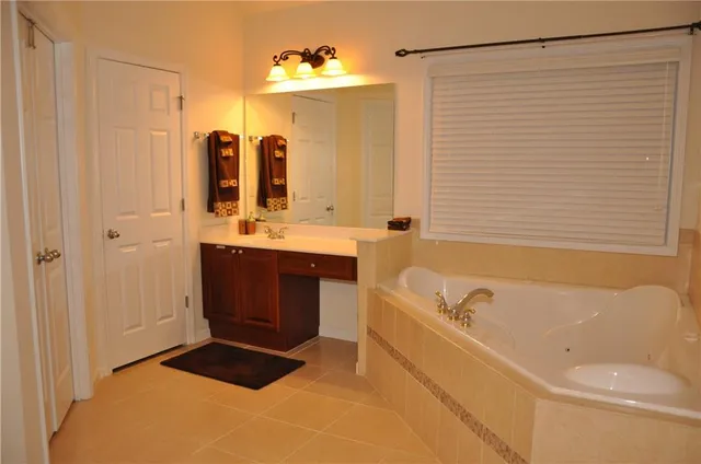 a bathroom with a bathtub a sink and a shower