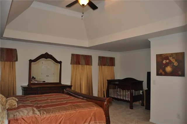 a bedroom with a bed and a television