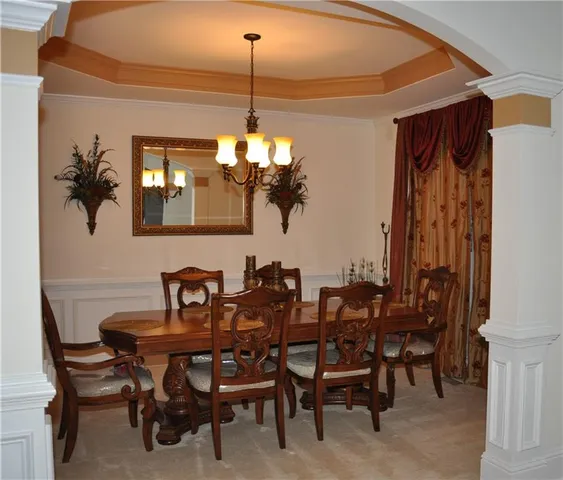 a view of a dining room with furniture and chandelier