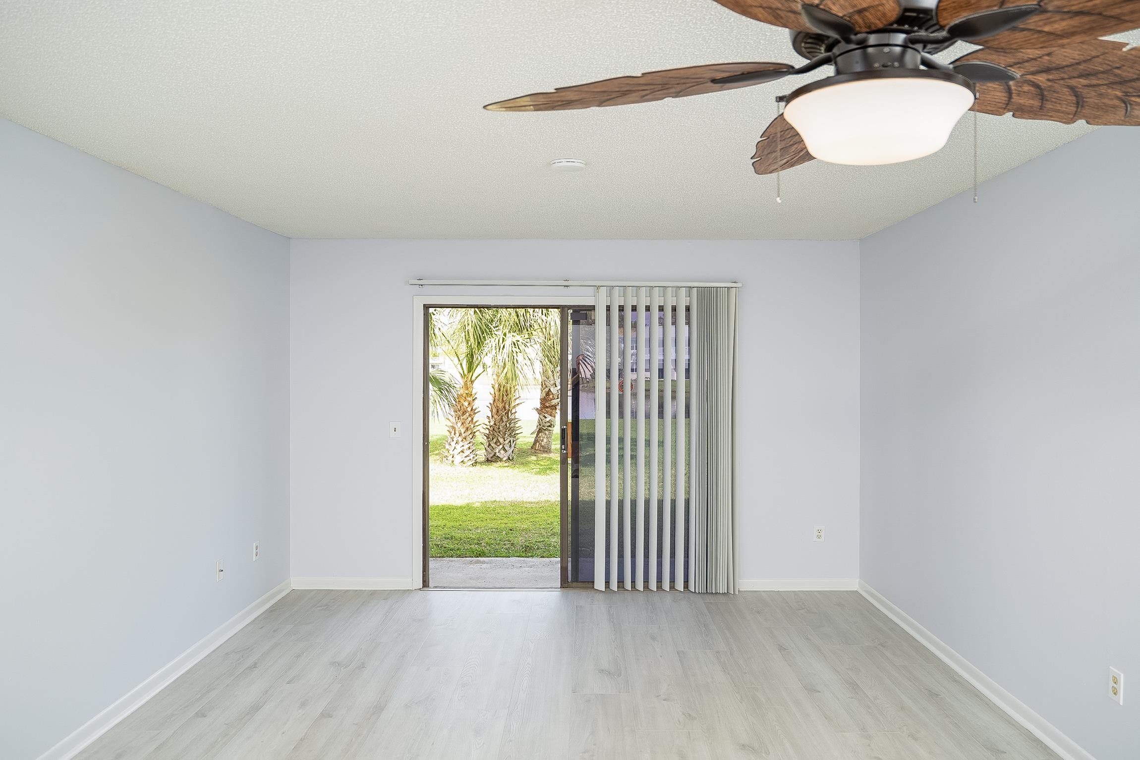 700 West Pope Road, Unit H57 St. Augustine, FL 32080 - Photo 11 of 52 Empty room featuring a ceiling fan and light wood-style flooring