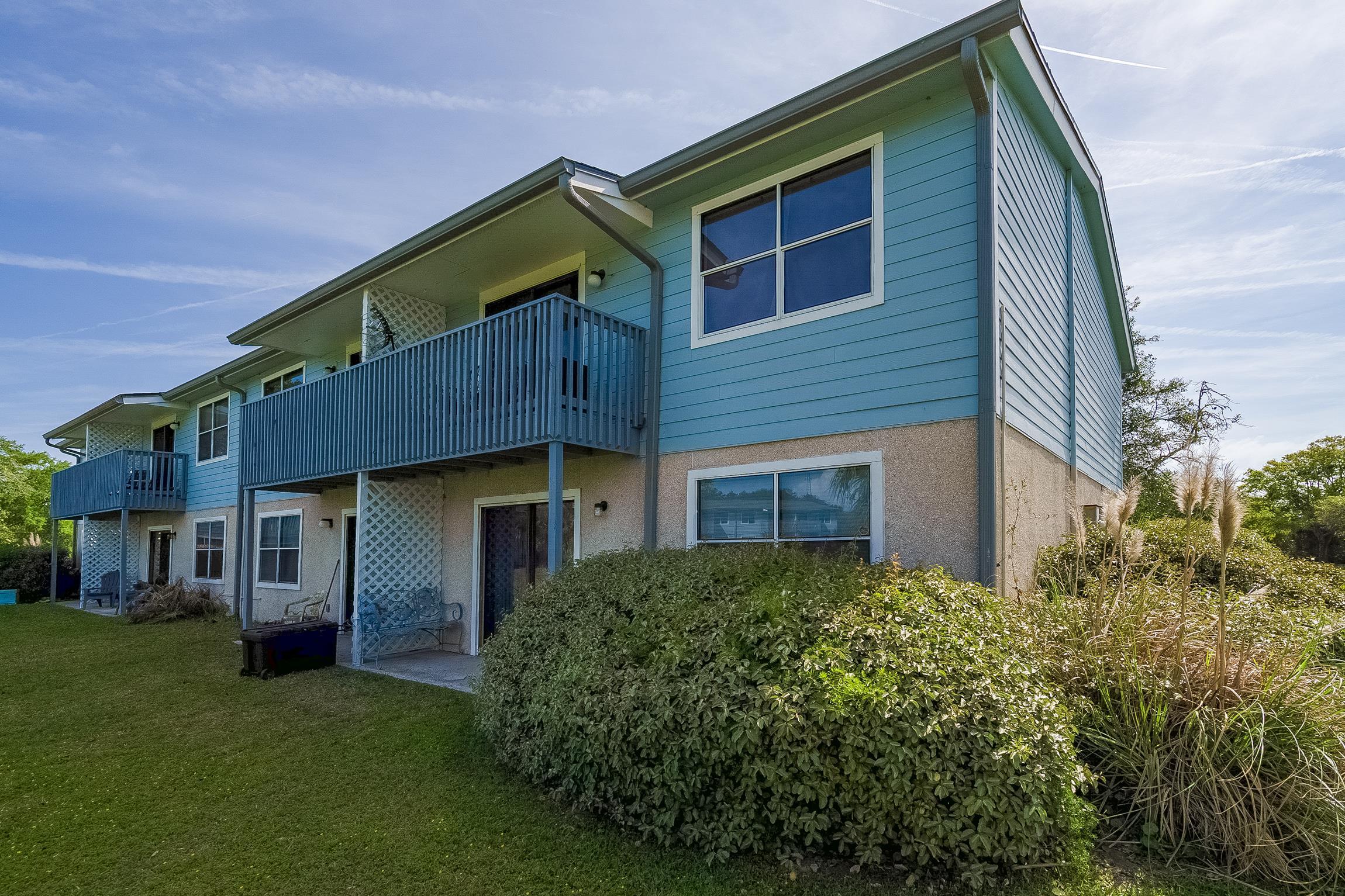 700 West Pope Road, Unit H57 St. Augustine, FL 32080 - Photo 15 of 52 Rear view of house featuring a balcony, a patio, a lawn, and stucco siding