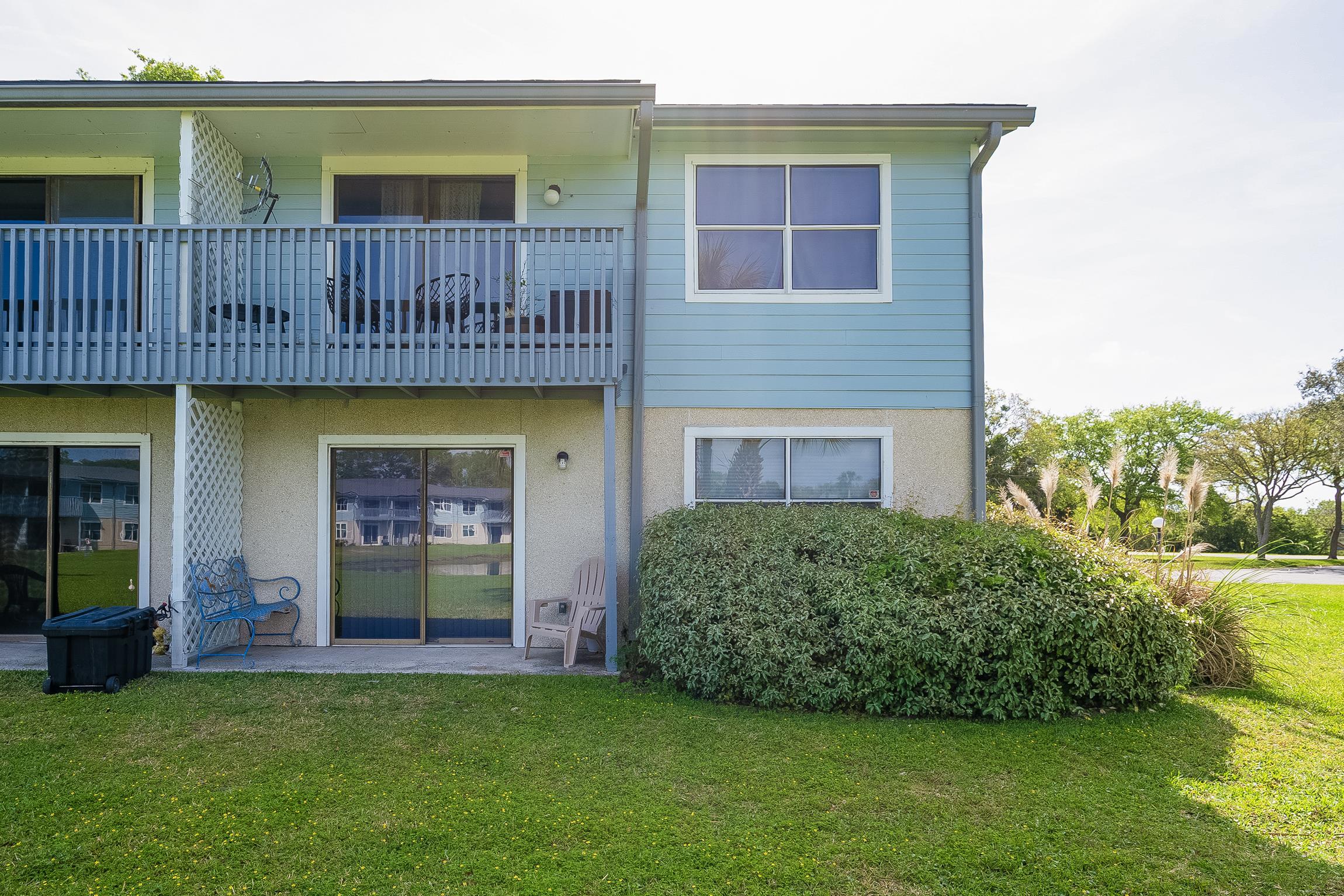 700 West Pope Road, Unit H57 St. Augustine, FL 32080 - Photo 16 of 52 Rear view of property featuring a patio, a yard, a balcony, and stucco siding
