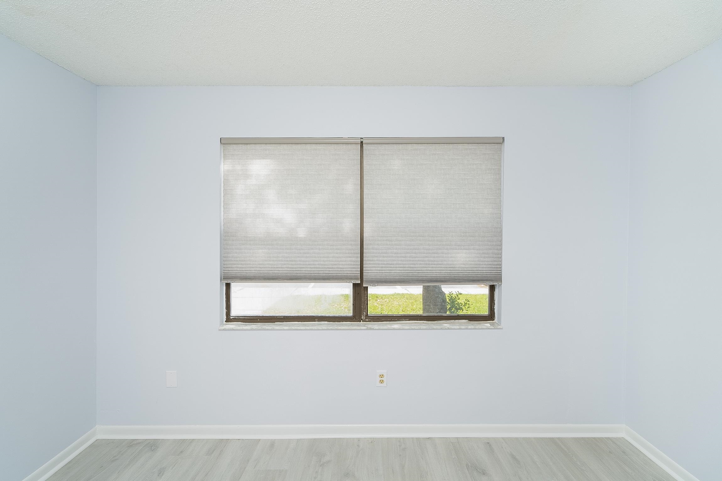 700 West Pope Road, Unit H57 St. Augustine, FL 32080 - Photo 20 of 52 Empty room featuring light wood-style flooring and a textured ceiling